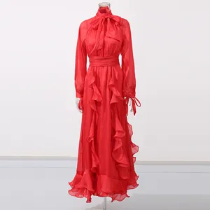 Elegant red retro court style ruffled maxi dress with bow-tie neck on mannequin