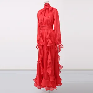Elegant red vintage maxi dress with ruffled detailing and bow-tie neckline on mannequin.
