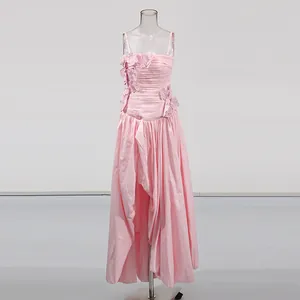 Detailed view of pink sweet-style gown with floral appliques and asymmetrical slit hem