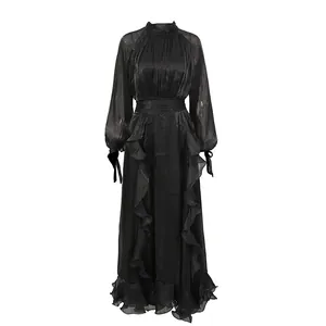 Detail of vintage palace style black ruffled dress with stand collar and shimmering fabric