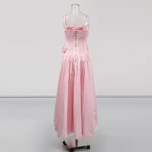 Back view of a sweet pink dopamine-style strap long prom dress with corset detail
