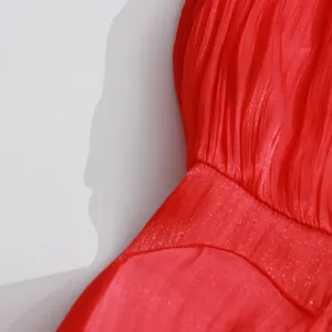 Detailed close-up showing the textured pleated fabric of a vintage red court style dress