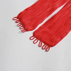 Close-up view of red pleated dress sleeves featuring elegant loop button fastener details.