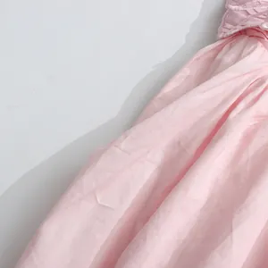 Close-up detail of light pink pleated fabric on a sweet style slip evening dress gown