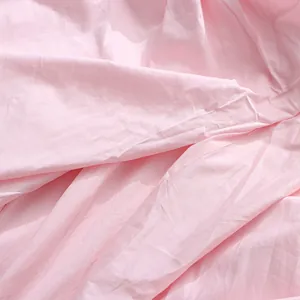 Detailed macro view of soft pink cotton fabric texture for a dopamine style summer dress