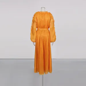 Back view detail of orange silk-look pleated maxi dress on mannequin showing waist and sleeves.