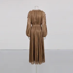 Back view of elegant bronze pleated maxi dress featuring shimmery silk-like fabric texture