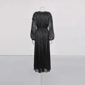Back view of a French style mercerized black long dress with sheer fabric details