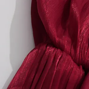Close-up of shiny burgundy mercerized fabric with elegant pleated texture