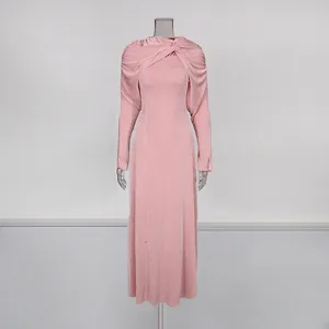 Elegant pastel pink slim fit maxi dress featuring a unique twisted shawl collar detail.