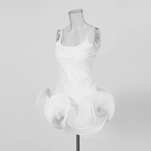 Detailed macro shot of white pleated ruffles and rhinestone bodice on celebrity style dress