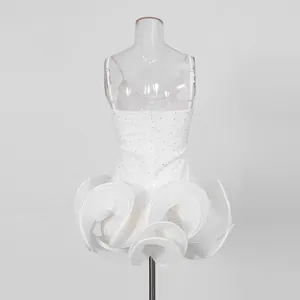 Detailed view of the rhinestone embroidery and layered ruffled hem of the white puff dress