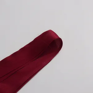 Close-up of elegant burgundy mercerized fabric showing subtle shiny texture and fine weave