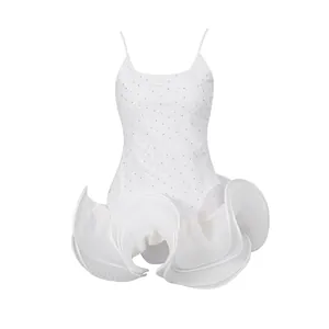 Detailed view of white French style strap dress with pleated ruffled hem and sequins