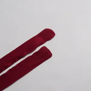 Close-up detail of glossy mercerized fabric strap on a burgundy French style dress