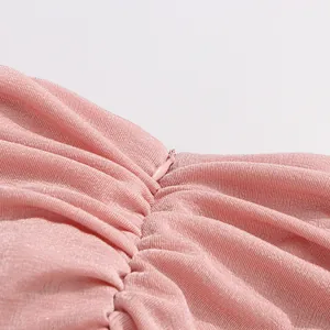 Detailed macro view showing the invisible zipper and textured pink elastic dress fabric