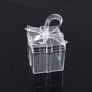 Macro detail of a transparent square gift box featuring a crystal-clear bow lid design