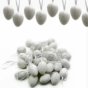 Detailed view of 24 speckled white Easter egg ornaments with hanging ribbons