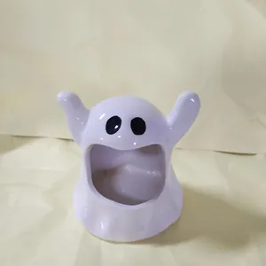 Detailed view of a cute ceramic ghost-shaped ashtray and creative desk ornament