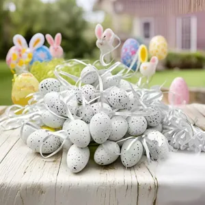 Close-up of 24pcs speckled white Easter eggs with ribbons for party decoration