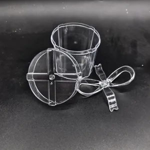 Detail view of transparent PS candy box showing lid and plastic bow decoration