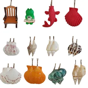 Variety of miniature hanging charms including frog, koi fish, and diverse seashells.