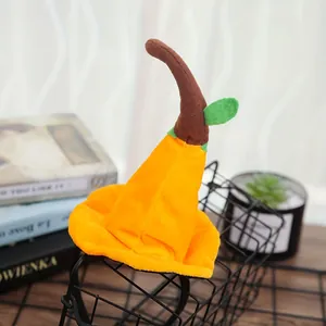 Close-up of a plush orange witch hat headband with a curved brown stem and leaf.