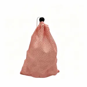 Detail view of a durable pink mesh drawstring bag for reusable plastic ice cubes