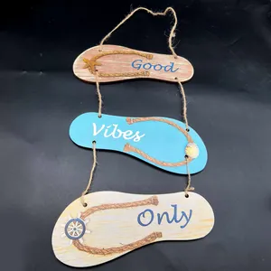 Detail of flip-flop shaped wooden hanging sign with Good Vibes Only text and rope