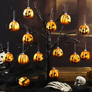 Set of 12 Halloween plastic pumpkin ornaments hanging on a black decorative tree
