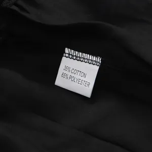 Détail de l'étiquette de composition 35% coton et 65% polyester sur robe noire