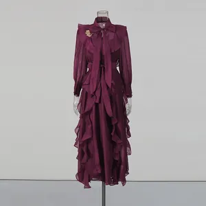 Elegant maroon chiffon ruffled dress with neck tie and gold butterfly metal decoration.