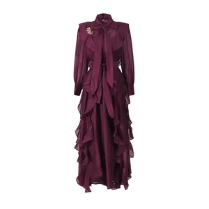 Detailed view of burgundy chiffon maxi dress with elegant ruffles and bow tie neck