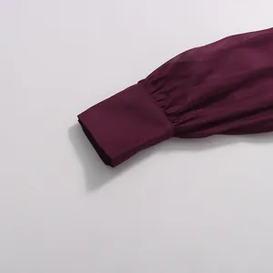 Detailed macro shot of a deep purple chiffon dress puffed sleeve cuff with pleats