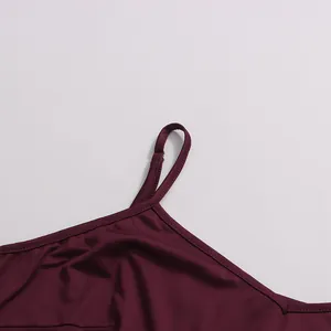 Close-up detail showing the adjustable thin shoulder strap on a burgundy satin dress
