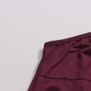 Close-up detail of the fine stitching on a dark burgundy chiffon dress neckline.