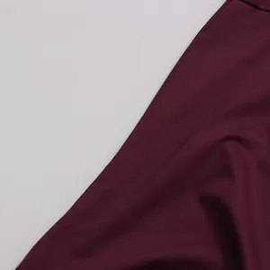 Detailed close-up of burgundy chiffon fabric texture showing soft drapes and weave.