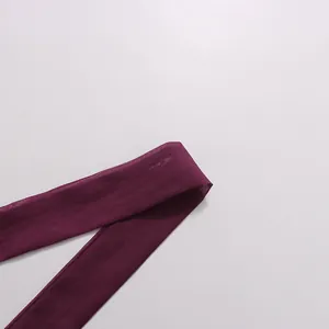 High-quality close-up showing the soft fabric texture of a deep purple neck tie strap