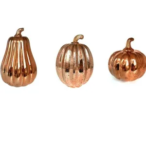 Set of three metallic rose gold decorative pumpkins for Halloween and Thanksgiving decor