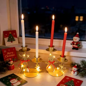 Detail view of festive reindeer and snowman iron candle holders with glowing LED lights