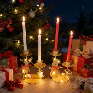 Golden Christmas reindeer and snowman candle holders with warm LED lights detail view.