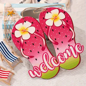 Detailed view of two watermelon wooden flip-flop welcome signs with summer beach props