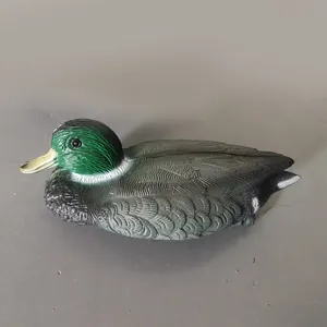 Side profile showing realistic feather texture and green head detail of the duck decoy.