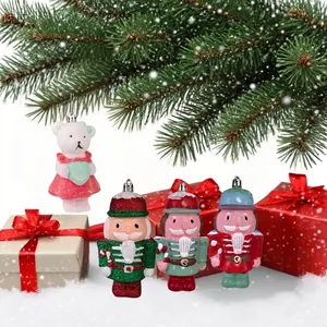 Detail showing glittery nutcracker and bear Christmas tree ornaments with gift boxes