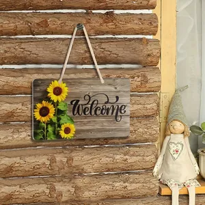 Rustic wooden welcome sign with yellow sunflower print hanging on a log wall detail
