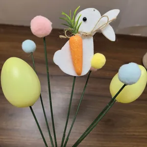 Close-up of Easter egg and felt bunny floral picks with colorful pom-poms.