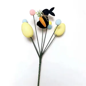 Easter decorative floral branch featuring a black bunny, carrot, and colorful eggs