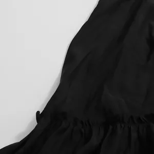 Gros plan détaillé sur l'ourlet à volants noirs d'une robe d'été vintage au fini soyeux