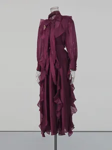 Elegant burgundy chiffon ruffled maxi dress with neck tie and metallic brooch accent