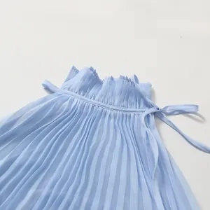 Close-up detail of light blue pleated dress with elegant ruffled stand collar
